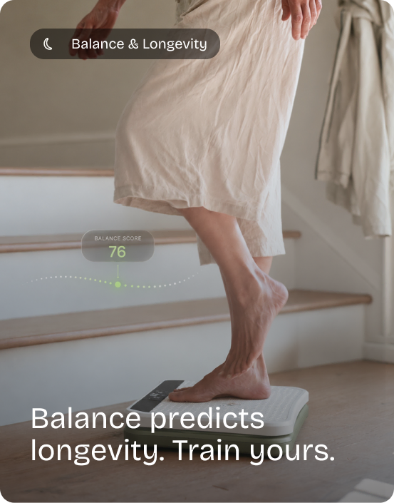 Woman steps onto the Kiwii Move board at the foot of the stairs, a balance score of 76 above her. Balance & Longevity: Balance predicts longevity. Train yours.